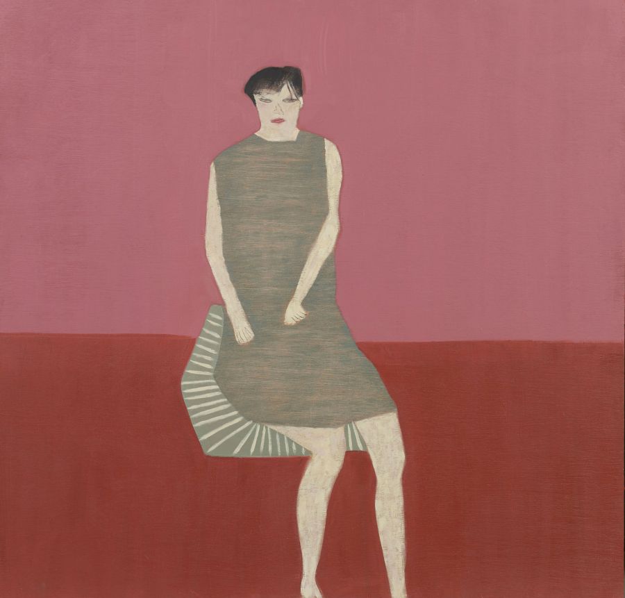 woman sitting in green silk dress against a red background.