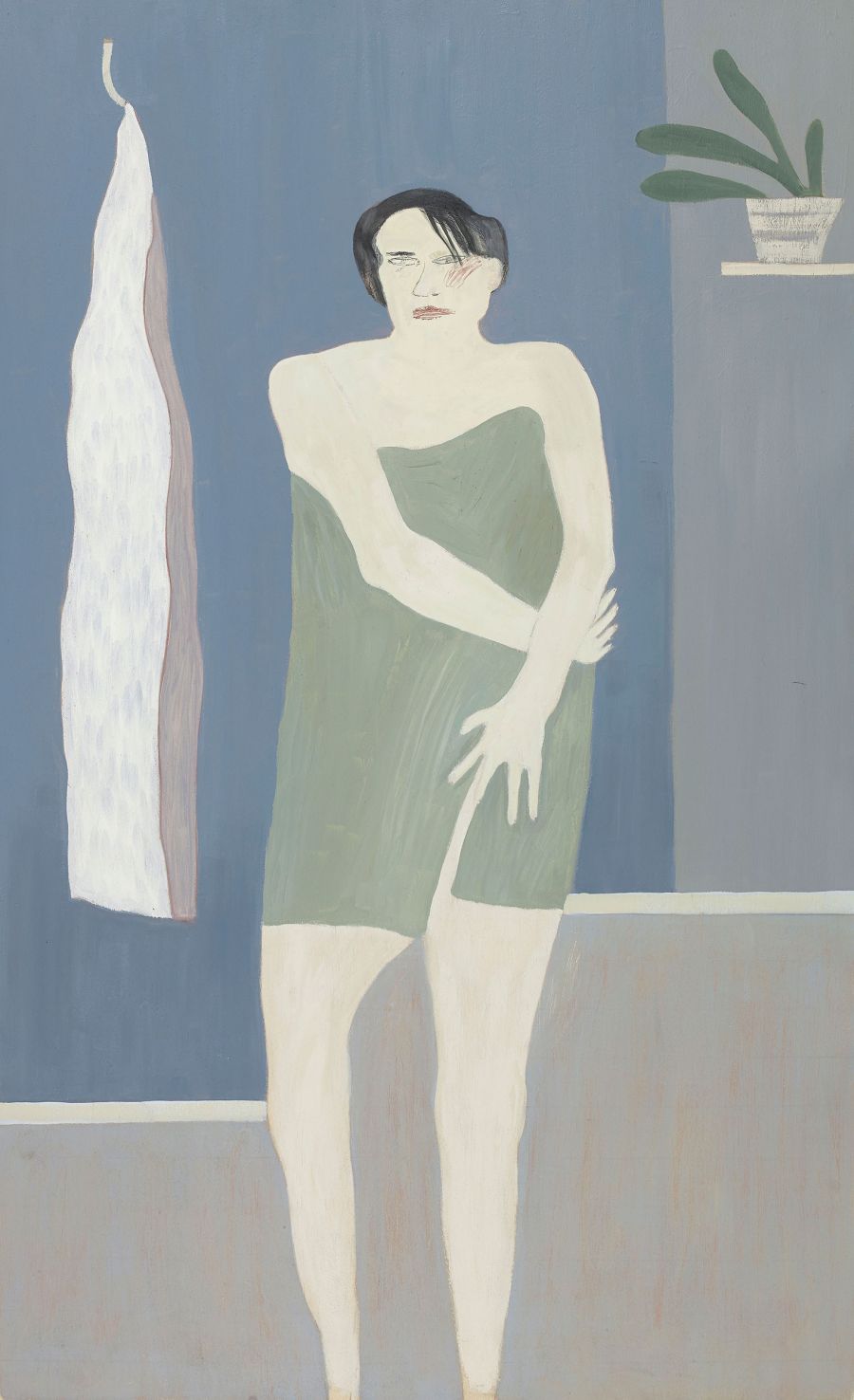 person wrapped in green towel standing.