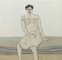 woman sitting on a bed.